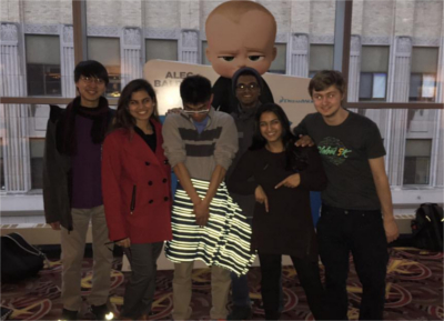 Picture of some of our community members posing in front of a Boss Baby cardboard cutout